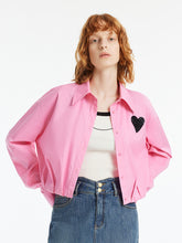 A lady wears a pink crop shirt.